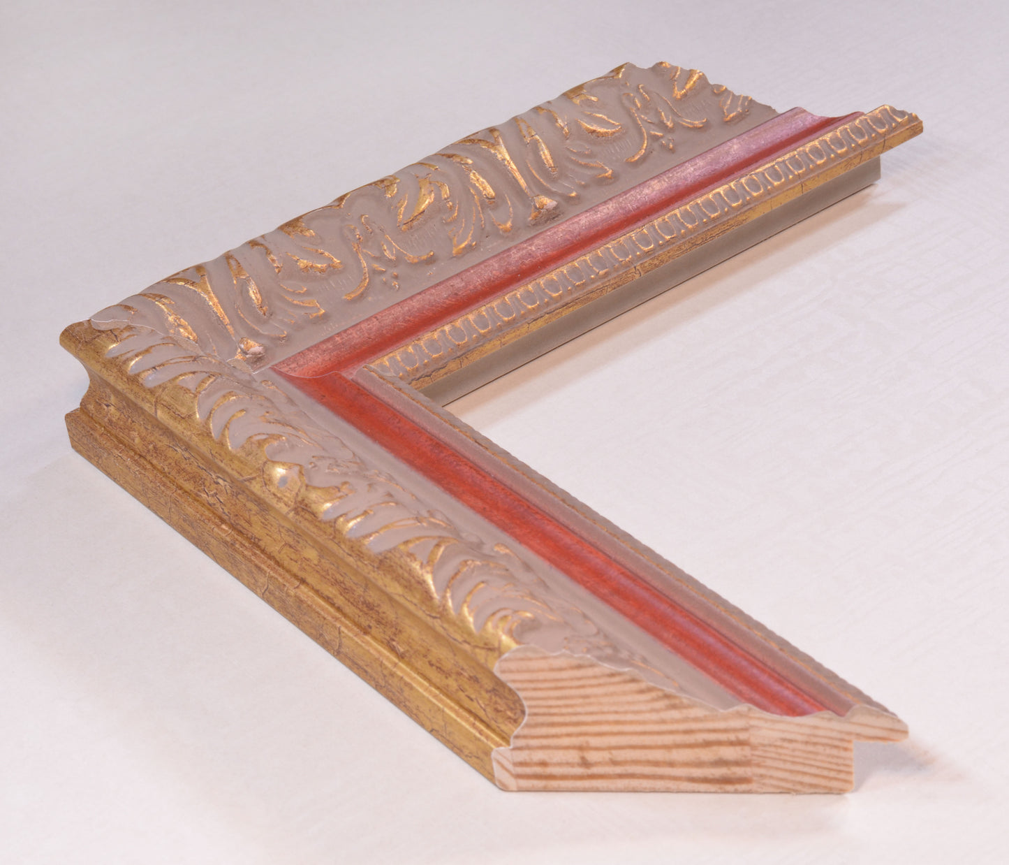 Antique gold picture frame on grey pink background with red stripe in classic style. 2.13" wide x 1.34" high.