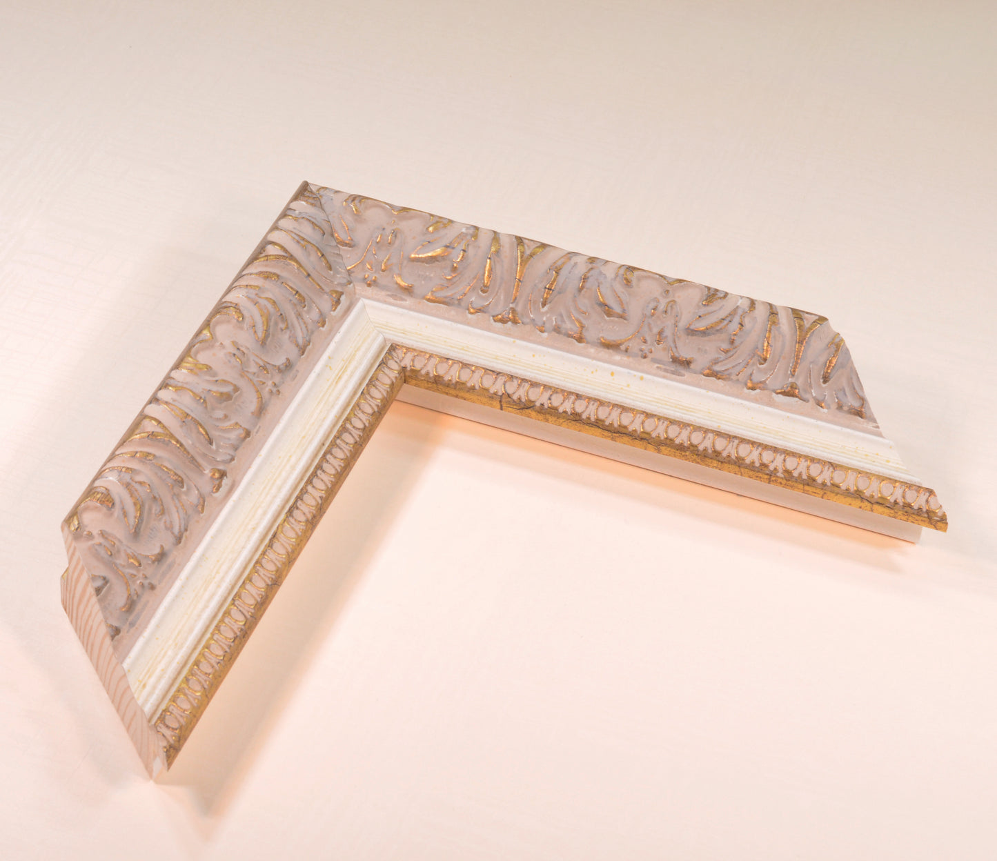 Antique gold picture frame on beige pink background with beige stripe in classic style. Width 2.13 inches, Height 1.34 inches.