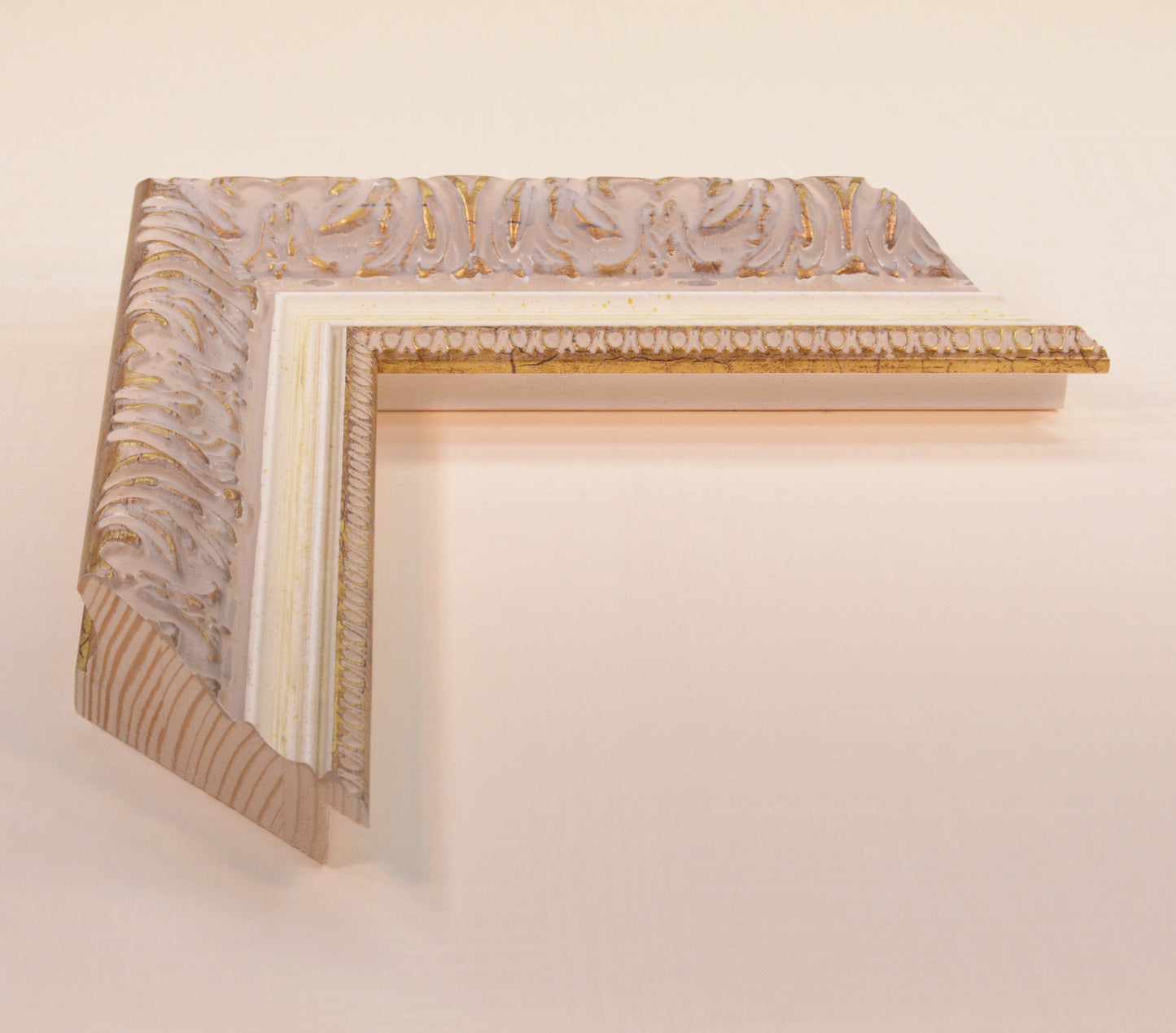 Antique gold picture frame on beige pink background with beige stripe in classic style. Width 2.13 inches, Height 1.34 inches.